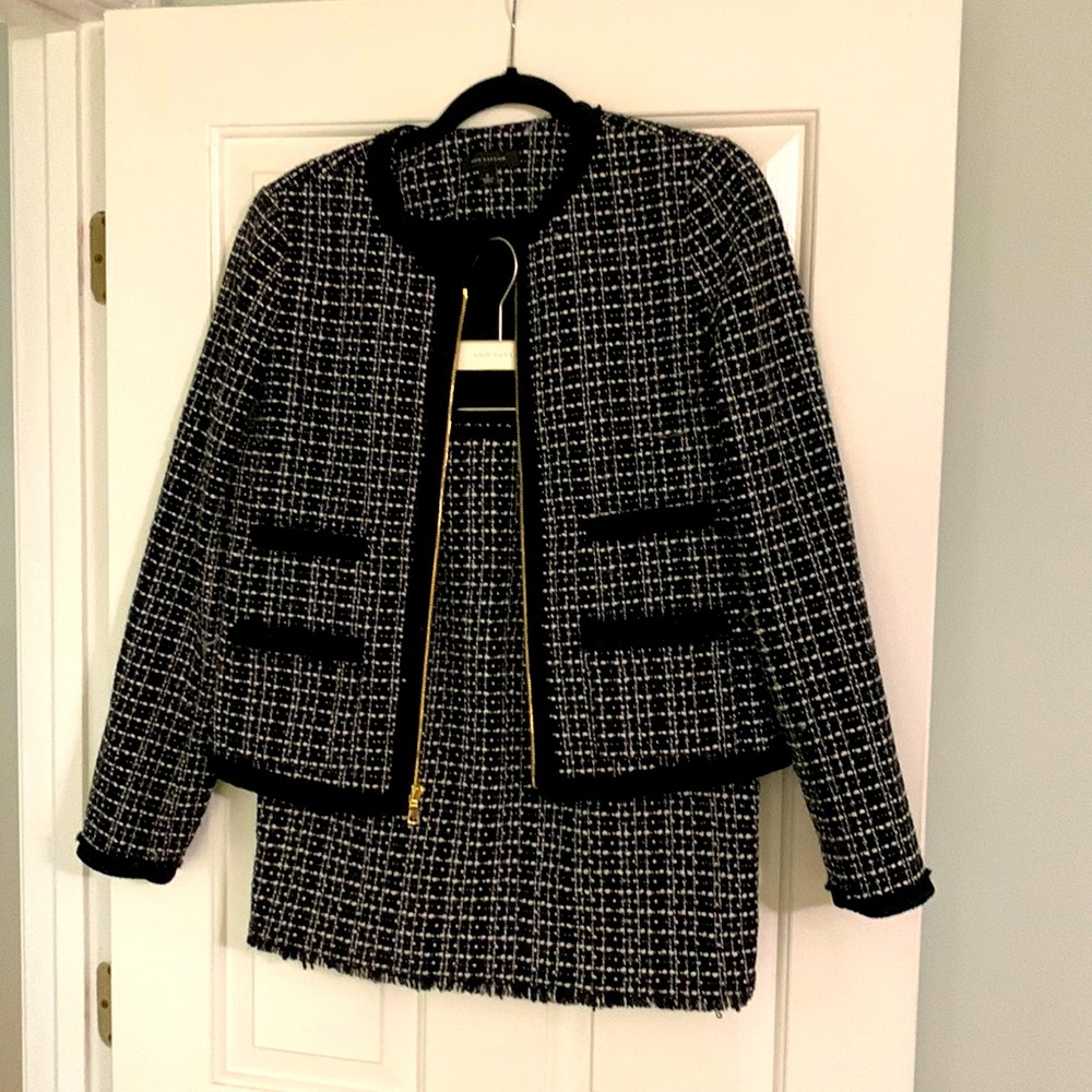 This is a two piece suit size 8p. The jacket zips up the front